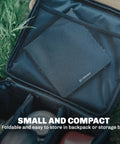 Featherweight Ultralight Folding Camp Table for Solo Camping and Backpacking folded in a black storage bag