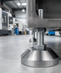 Beefy Heavy Duty Leveling Feet for Workbenches and Machinery, 2.36 Inch Base, shown supporting a machine in a workshop