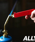 2-In-1 Pistol Rock Style Flint Striker with 12 Flints igniting a welding torch, demonstrating easy pull trigger start.