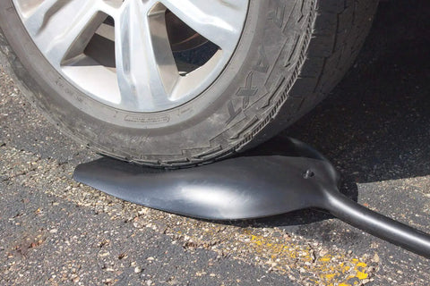 Durable Poly Snow Scoop Shovel For Quick Winter Cleanup with 42 inch handle under car tire, highlights heavy duty plastic strength.