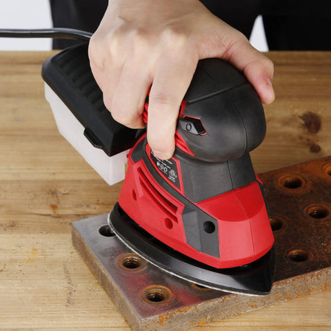 Hand using Powerful Hand Sander For Woodworking, 14,000 OPM Detail Sander With Vacuum Dust Box on metal surface