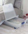 Open Two Pack 66 Quart Clear Underbed Storage Bins With Low Friction Wheels And Snap Tight Blue Latches showing gift wrap inside.