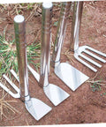 Durable Stainless Garden Hoe For Weeding, Digging, And Soil Prep with pointed heads and ergonomic handles on dirt surface