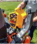 Tough 5 Gallon Type Ii Safety Jerry Can In Bright Yellow held near equipment, showcasing ergonomic thumb trigger and rotating spout.