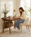 Score This Legit 47 Inch Solid Wood Writing Desk With Warm Walnut Finish spacious desktop and a woman writing at it.