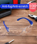 Heavy Duty Safety Glasses Bulk Pack With Clear Lenses And Durable Blue Frames Engineered For The Daily Grind No Nonsense Eye Guard Gear For Job Sites Labs And Working Crews on a wood surface with tools.