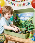 Child playing with Rainforest Diorama Kit With 33 Pieces PVC Animals And Insects, Miniature Trees, Moss, Sand And Stones at birthday party