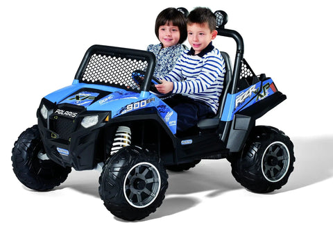 Two children sitting in a blue ride-on Polaris RZR 900 toy car with visible front and side design.
