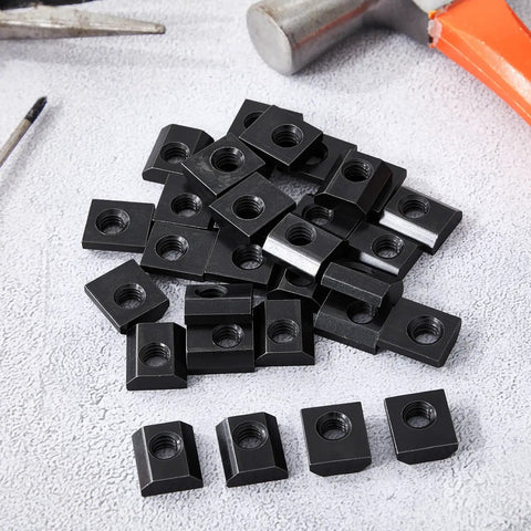 Pile of Bulk Pack Of 100 Slide In T Nuts 15 Series Five Sixteenths By Eighteen UNC Threaded Steel T Nuts For Aluminum Extrusion