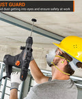Worker using Heavy Duty SDS Plus Rotary Hammer Drill 1-1/4 Inch, 12.5 Amp on ceiling with dust guard feature shown