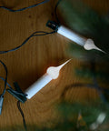 Beefed-Up Value Pack Of 6 Silicone Light Bulbs With Champagne Exterior, 7.5W Medium Base, clipped to a surface, emits warm glow