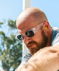 Man wearing Top Shelf Clear Frame Polarized Safety Glasses Osha Approved Ansi Z87 Plus Certified during work outdoors.