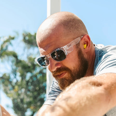 Man wearing Top Shelf Clear Frame Polarized Safety Glasses Osha Approved Ansi Z87 Plus Certified during work outdoors.