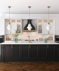 Kitchen with three 9 Inch Wide Pendant Lights With Glass Shade In Brass And White Milk Glass, over a central island.