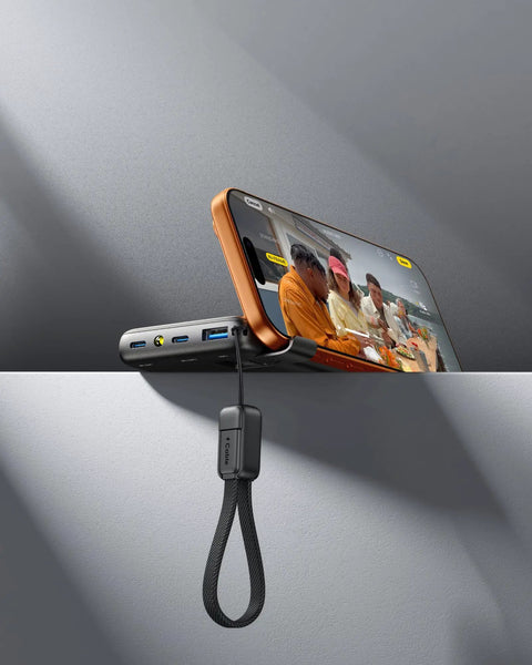 Throw This Compact 10000 Mah Power Bank In Your Pocket For Immediate Relief Packs 45W Usb C Pd Fast Charge For Phones Consoles And Laptops, showing power bank with attached nylon tether.