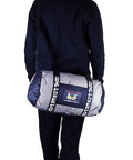 Man carrying Breathable Mesh Gear Bag Built Heavy Duty For Gym Beach Swim Scuba Sports Dive And Outdoor Use, side view.