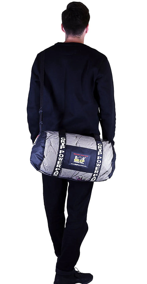 Man carrying Breathable Mesh Gear Bag Built Heavy Duty For Gym Beach Swim Scuba Sports Dive And Outdoor Use, side view.