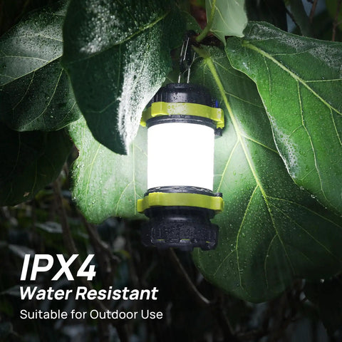 Two Pack LED Camping Lantern And Flashlight Rechargeable with USB C Port hanging on wet leaves showcasing IPX4 waterproof feature.