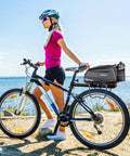 Cyclist with Hard Shell Waterproof Bike Rack Bag For Rear Carrier 9.5L 17L And 40L Capacities, black bag attached on bike.
