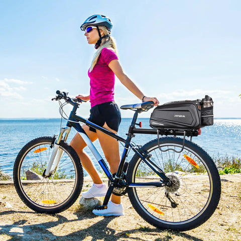 Cyclist with Hard Shell Waterproof Bike Rack Bag For Rear Carrier 9.5L 17L And 40L Capacities, black bag attached on bike.