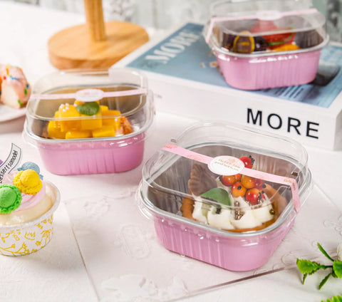 Heavy Duty Square Aluminum Foil Cake Pans 50 Pack Hot Pink 10oz With Secure Snap Lids holding colorful desserts on a table.