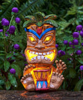 Solar Powered Tiki Statue Light For Garden, Patio, And Backyard Decor, Waterproof Outdoor Tiki Bar Totem Pole Figurine, 10 Inch Tall Garden Ornament For Walkways, Balconies And Lawn in a lush garden setting