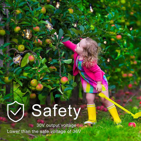 Child reaching for apples with 52 Foot Dimmable LED Outdoor String Lights With Remote Dimmer Waterproof Patio Lighting visible in background.
