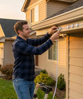 Man installing 90 Pack Light Clips For Pro Outdoor Lights H706 H806 on eave with enclosed brackets and screws, no glue needed