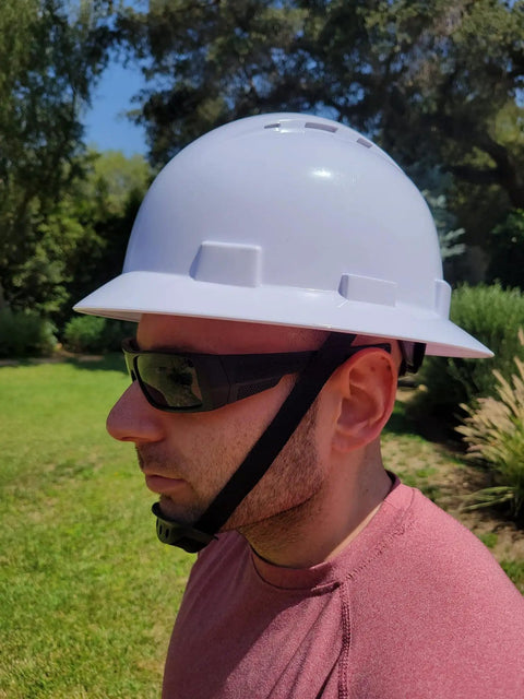 Man wearing Job Site Ready Full Brim Vented Hard Hat With 6 Point Ratchet System in garden
