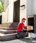 Delivery person placing package at home entrance beneath LED Illuminated Address Plaque With Solar Power For Home Exterior
