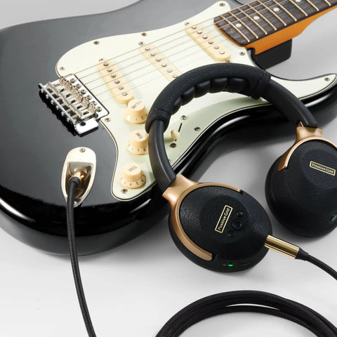 Black guitar with Spark NEO Wireless Guitar Headphone Amp And AI Powered Guitar Rig; includes headphones and cable