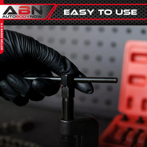ABN chain breaker tool with T-handle and screw clamp; gloved hand operating the clamp; red storage case in background