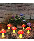 Image of 8 Pack Red Mushroom Solar Lights For Outdoor Garden Decor With 8 Lighting Modes, festive vibe in garden setting