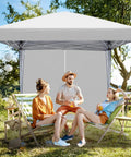 Easy Setup 10x10 Pop Up Canopy Tent With Sidewalls For Outdoor Parties Quick Takedown Gazebo Shelter Durable Patio Event Tent For Backyard BBQs And Get Togethers Adjustable Height And No Tools Needed providing shade in a garden setting with people seated underneath