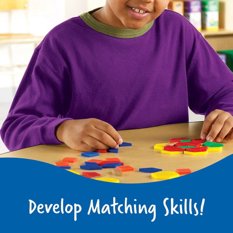Child using Pattern Block Set With 250 Pieces For Geometry And Pattern Design, Classroom Must Haves, Homeschool Math Tools, in purple shirt.