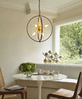 Modern Sputnik Style 6 Light Starburst Chandelier, 18-Inch Globe Fixture In Black And Gold, dining room setting.
