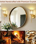 Two Pack Crystal Rechargeable Wireless Wall Sconces Featuring Brushed Gold Finish With Adjustable Dimming Remote And Multi Hue Settings Built For Super Quick Mounting And Zero Wiring Hassles Ever. Crystal glass sconce beside a round mirror.