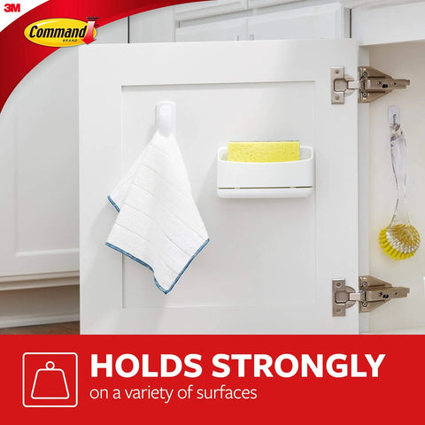 Medium White Spring Clip With Three Strips For Damage Free Hanging holding a dish towel on a cabinet door.