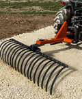 49 Inch Pine Straw Rake for Tractors with 17 Spring Steel Tines for a 2 Inch Receiver attached to tractor clearing debris