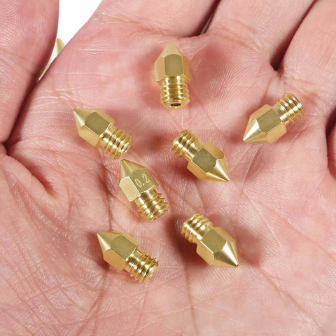 Eight 0.6mm MK8 Extruder Nozzles for 3D Printers, High Quality Replacement Nozzles, held in hand