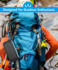 Maxed-Out 49800mAh Solar Power Bank With 15W Fast Charging attached to hiker's backpack for outdoor adventures
