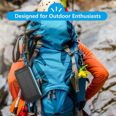 Maxed-Out 49800mAh Solar Power Bank With 15W Fast Charging attached to hiker's backpack for outdoor adventures