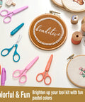 Two Piece High Precision Detail Scissors Set With Sharp Fine Tips in Pastel Purple and Pink with crafting supplies on table.
