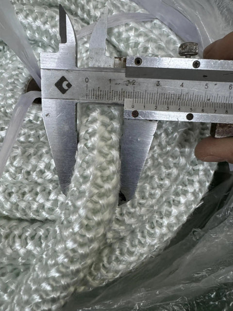 Close-up of Graphite Impregnated Fiberglass Rope Seal Gasket For Wood Stoves 14mm By 2m White Replacement Heat Resistant Door Seal
