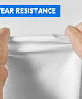 Hands stretching Heavy Duty 10X20 Ft White Tarp 12Mil Waterproof UV Resistant Multipurpose Sheet showing tear resistance.