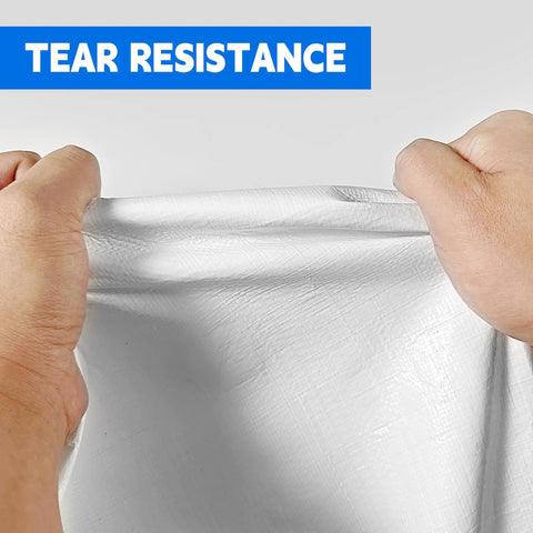 Hands stretching Heavy Duty 10X20 Ft White Tarp 12Mil Waterproof UV Resistant Multipurpose Sheet showing tear resistance.