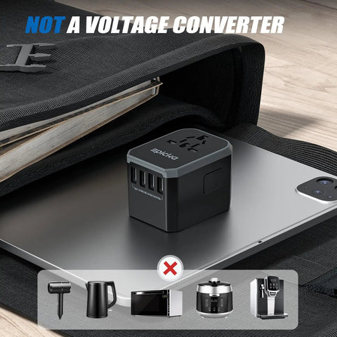 All In One Universal Travel Adapter With USB C And Four USB A Ports Worldwide Power Adapter For Over 200 Countries Not A Voltage Converter placed on a laptop
