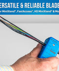 Hand using Replacement Blade Set For MS 326 Fiber Optic Mid Span Slit And Ring Tool on colorful fiber optic cables