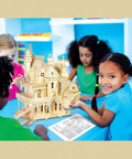 Children building a detailed castle wooden model kit in a vibrant classroom setting.