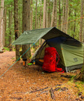 Beefy Weatherproof Canvas Tarp For Outdoors Highly Durable Waterproof Tarpaulin Shelter in forest campsite over red backpack